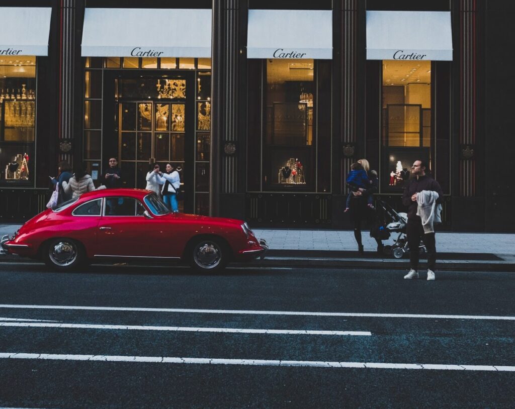 red coupe infront of cartier shop